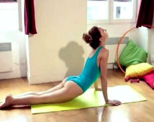 Damsel gymnast chick practising yoga in bathing suit at